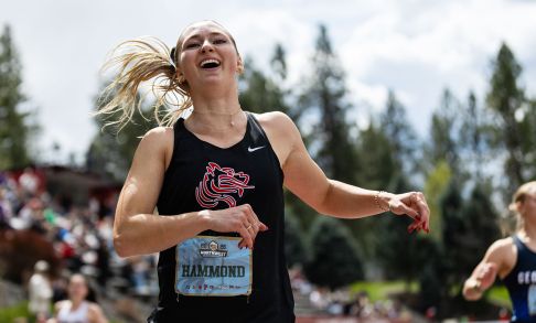 Photo of Ally Hammond. She has blonde hair pulled back from her face and is wearing a black singlet with a red Pacific Boxer head logo on it.