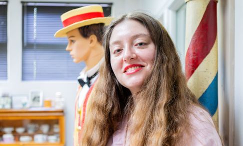 Elle Griego '26 In Front Of Displays Honoring Forest Grove's Gay 90s Festival