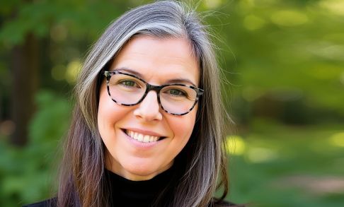 Headshot of Jessica Scruggs DHS '09. She has long brown and gray hair and is wearing a black shirt and brown glasses.