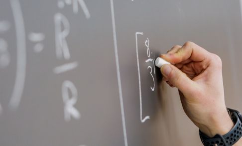 Hand Writing Science Equations On Chalkboard