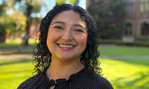Headshot of Rebeka Andrade in front of Marsh Hall