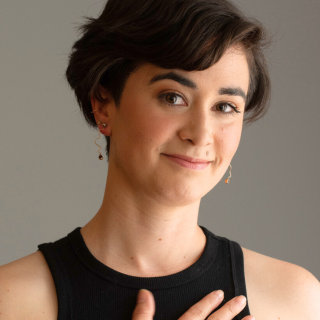 photo of Caitlin Lushington, short brown hair and smiling