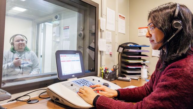 Audiology student practices testing at Pacific Ear Clinic