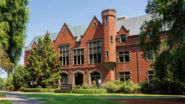 A photo of Pacific University's Marah Hall surrounded by green lawns.
