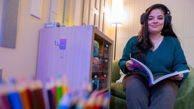 A Student Relaxes With A Book Inside Pacific's New Sensory Room