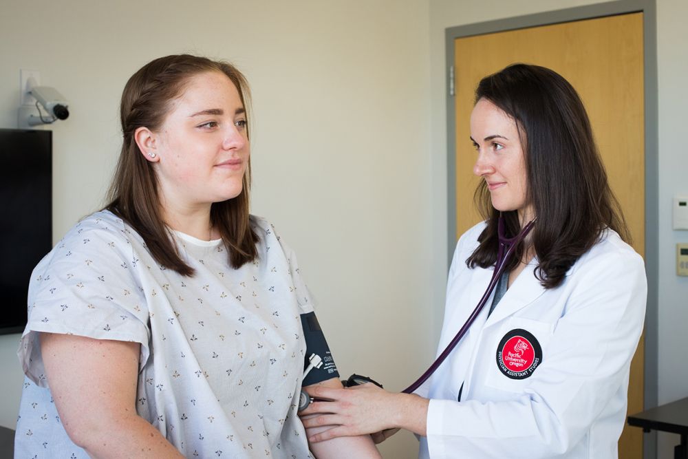 Student taking another student's pulse