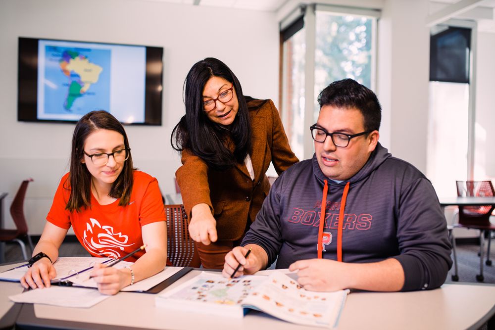 Professor teaching two students