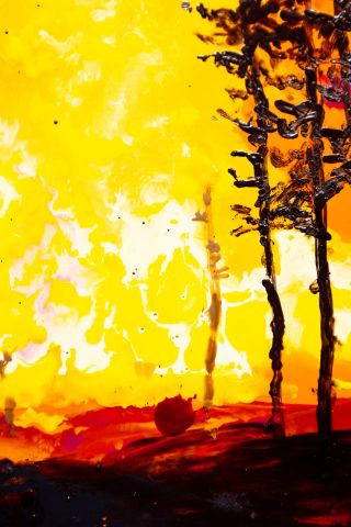 A depiction of a wildfire burning in yellow and red with black trees on the right side. A splotch of darker red is in the lower middle.