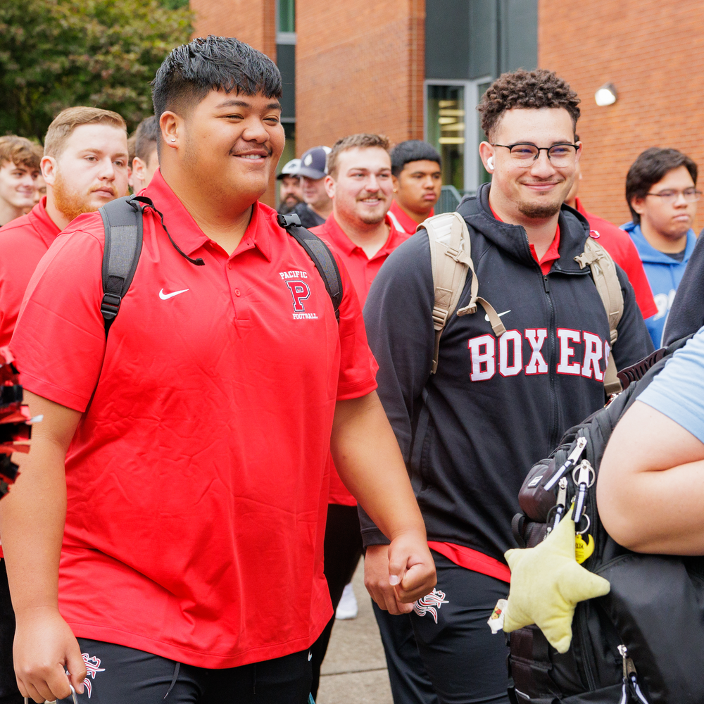 A group of Boxer student athletes parade through campus