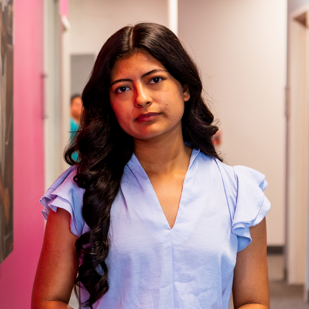 Nanci Rios '19 stands in the Adelante Mujeres office where she works as an immigration attorney.