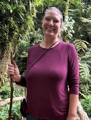 Bonnie Bolkan Standing On A Bridge And Holding A Hiking Stick
