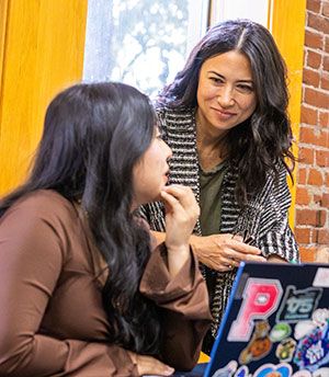 Rebecca Schoon In A Classroom Working With A Student