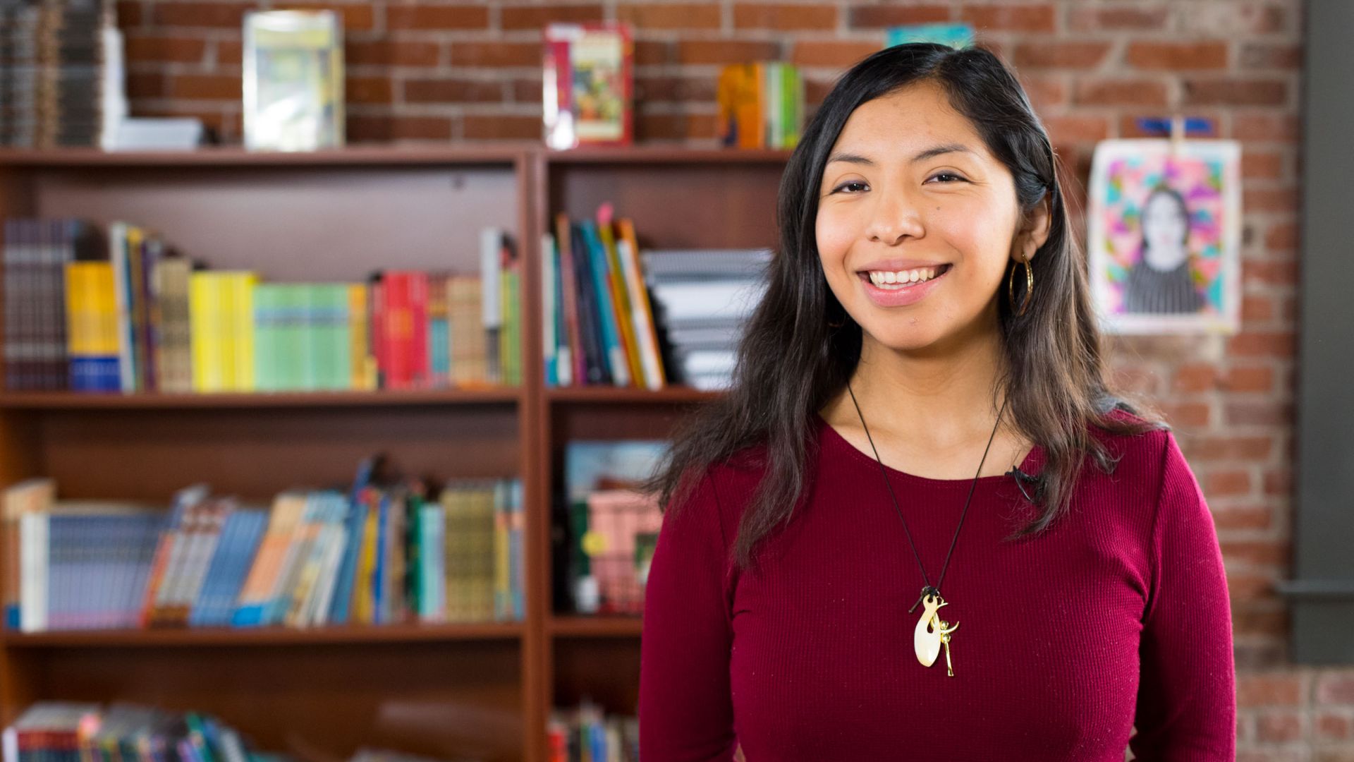 Denise Aquino in front of book shelves