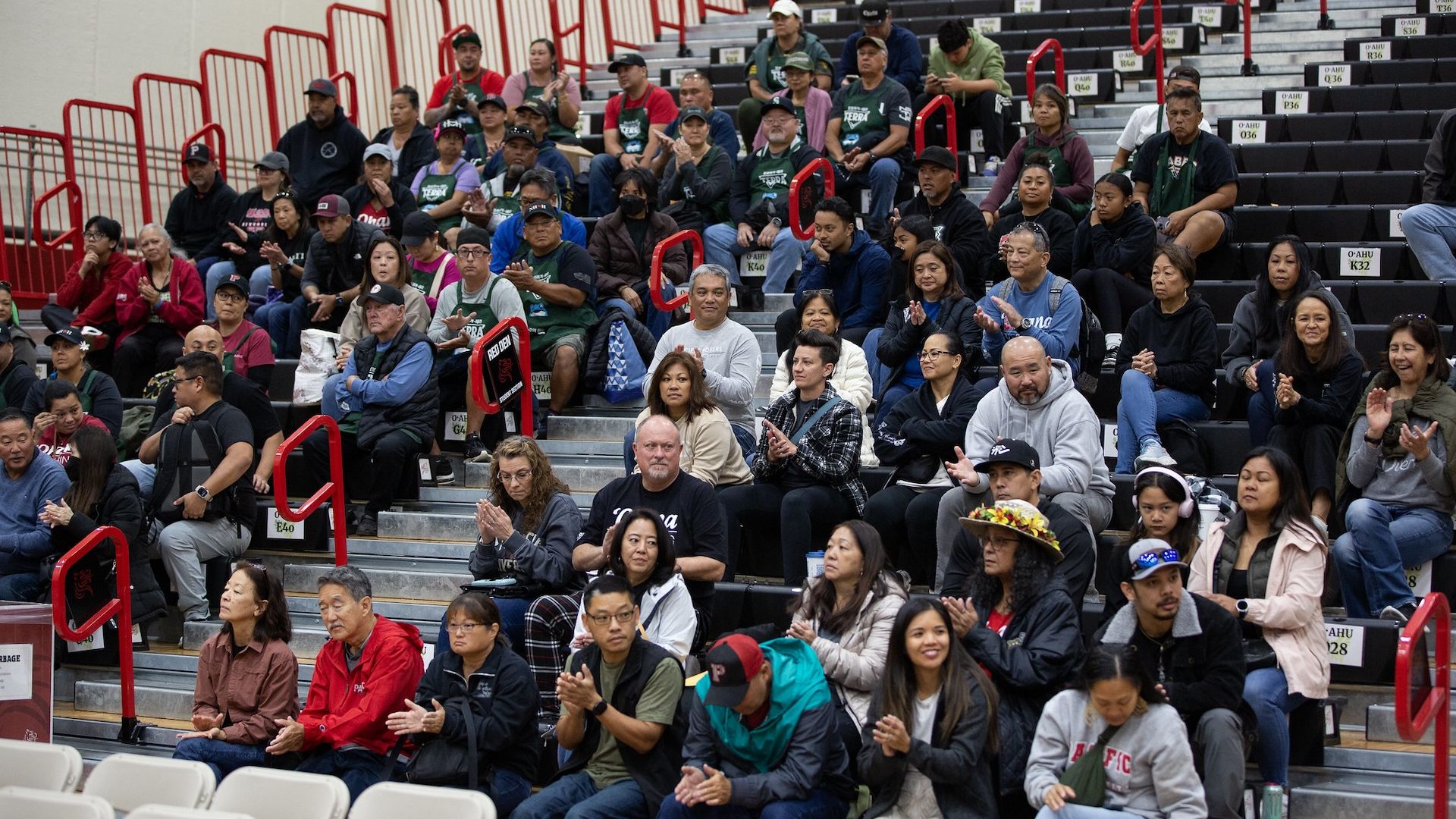 parents at an event in the bleachers
