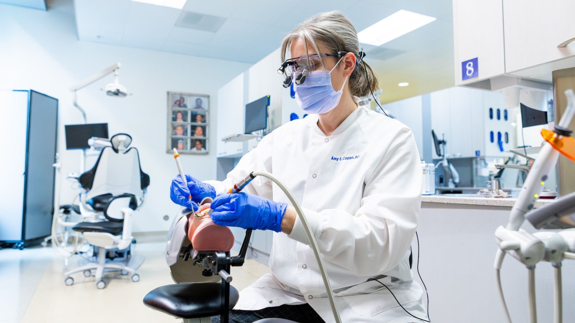 Dental therapy instructor in a lab