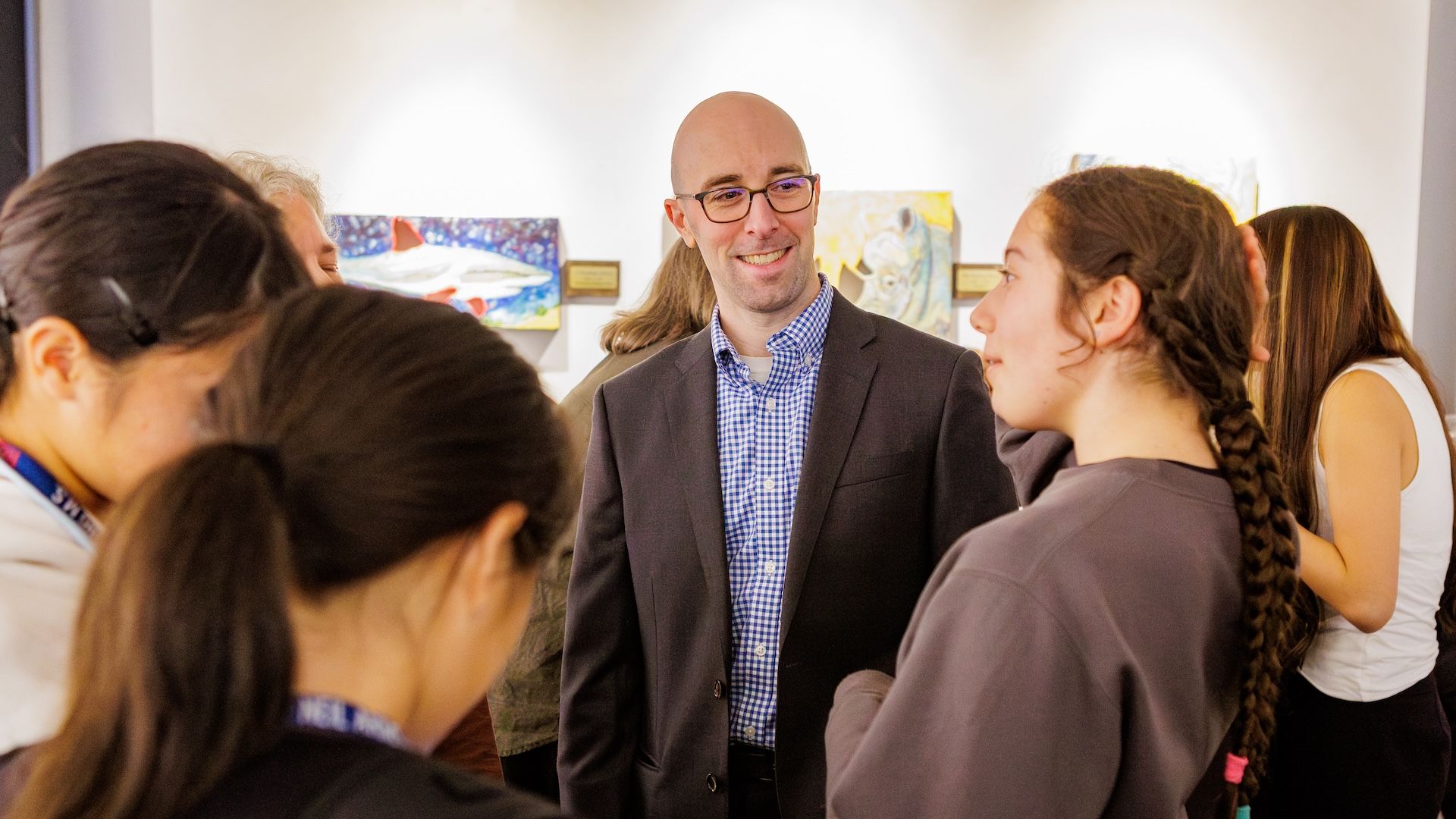 professor speaking with students at Senior Project Day
