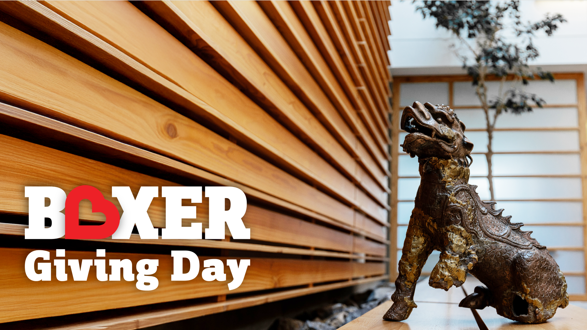 Boxer Giving Day Logo with Boxer Statue Sitting Next to It