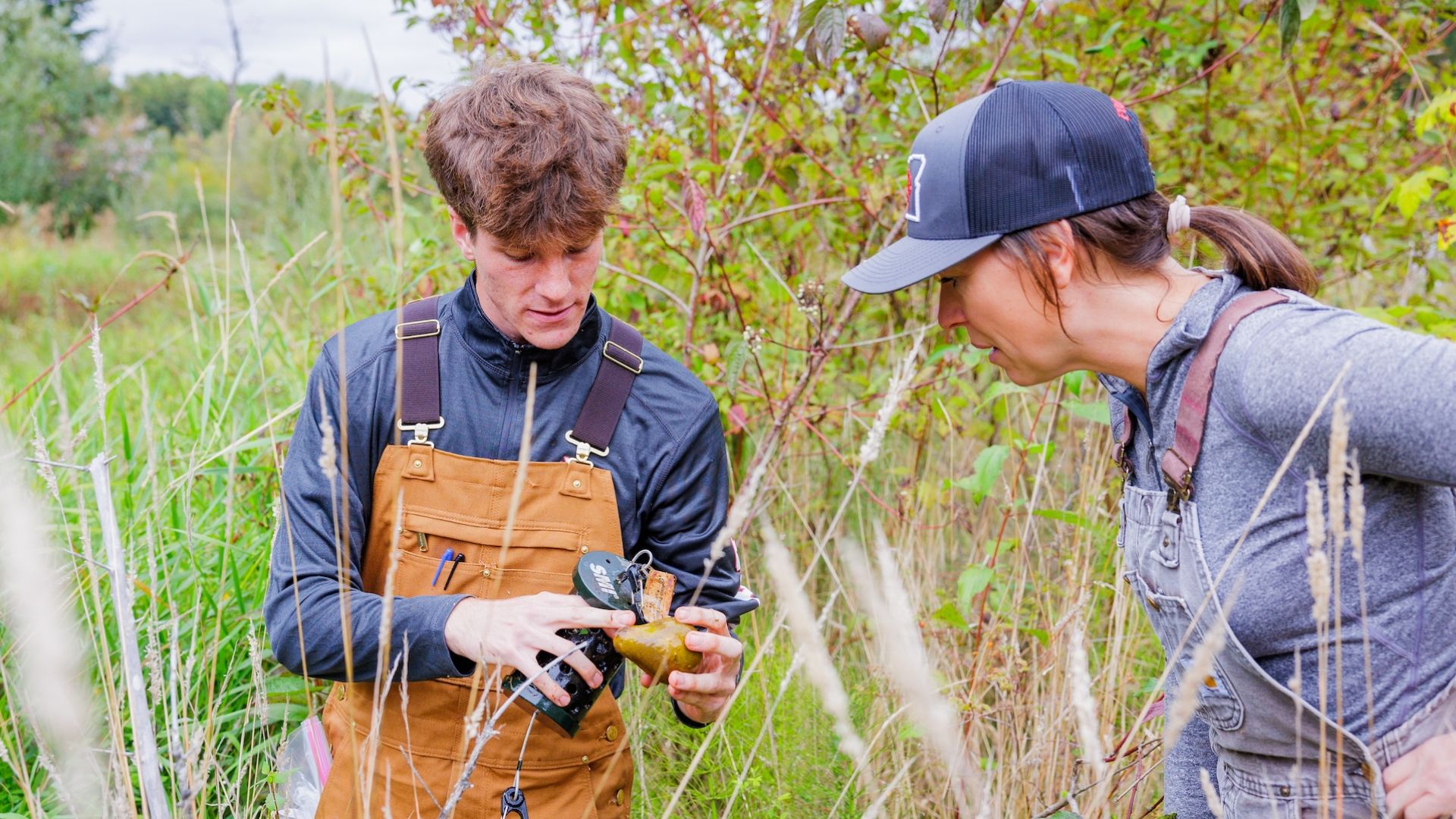 two Pacific University students working in nature on field work