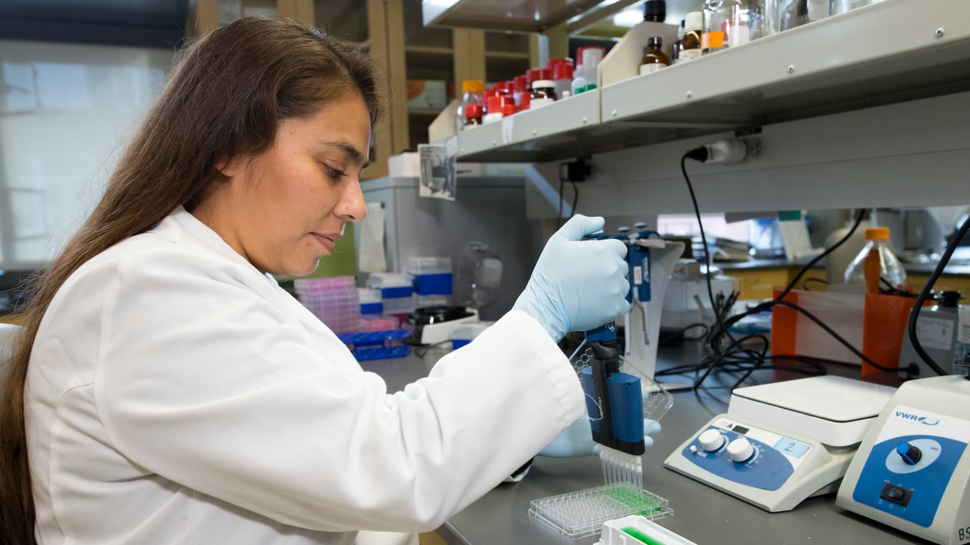 Pharmacy student works in the lab with equipment
