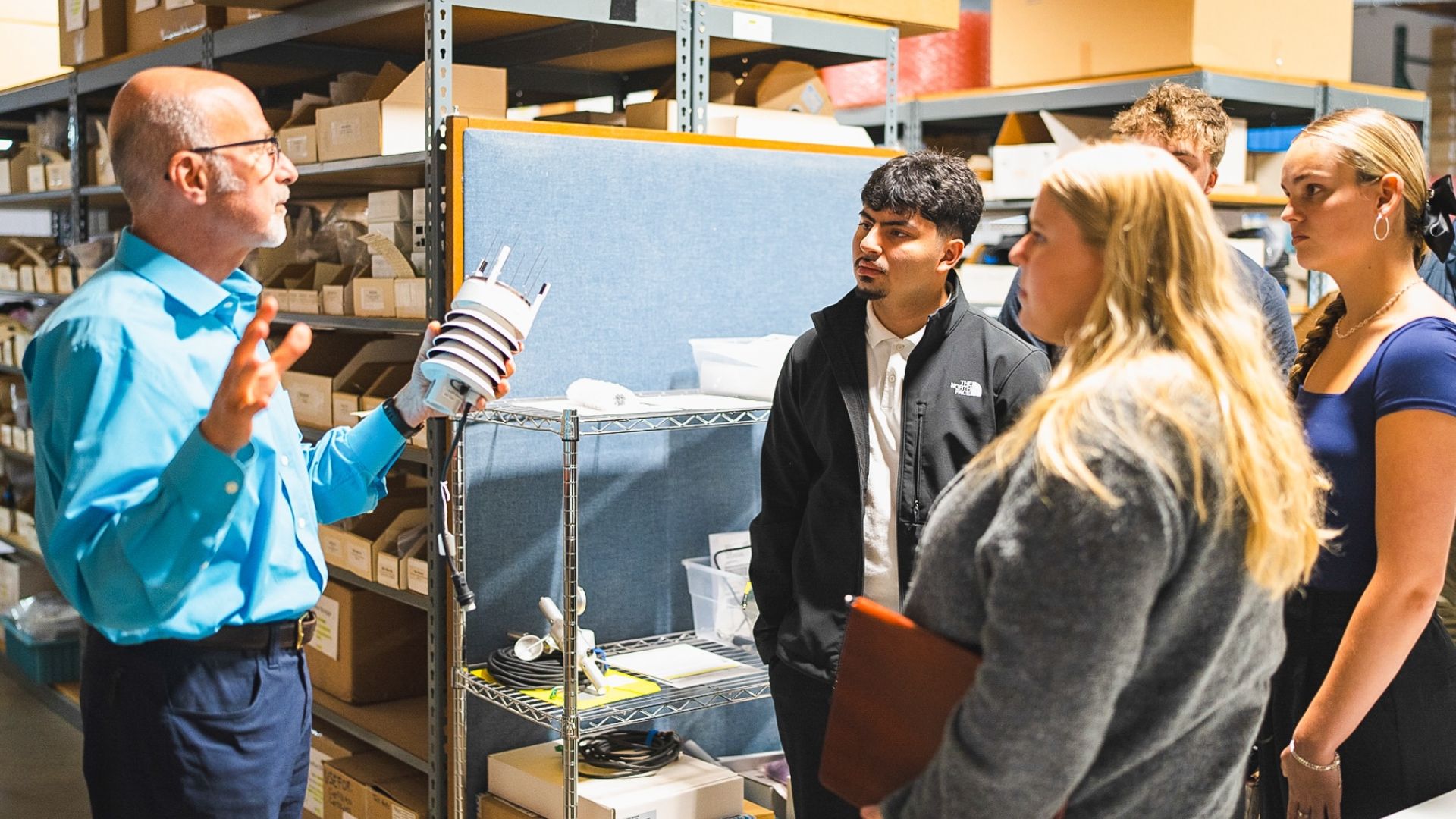 Pacific University students talk with a business owner 