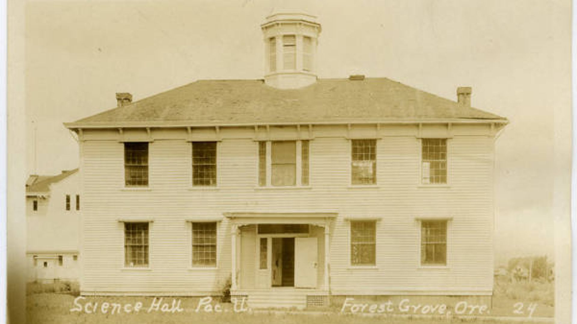 Postcard circa early 1900s of the front view of Old College Hall when it was called Science Hall at Pacific University. Gymnasium in the background.