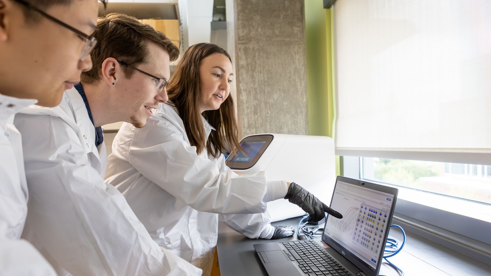 Pacific Pharmacy students look at a computer together