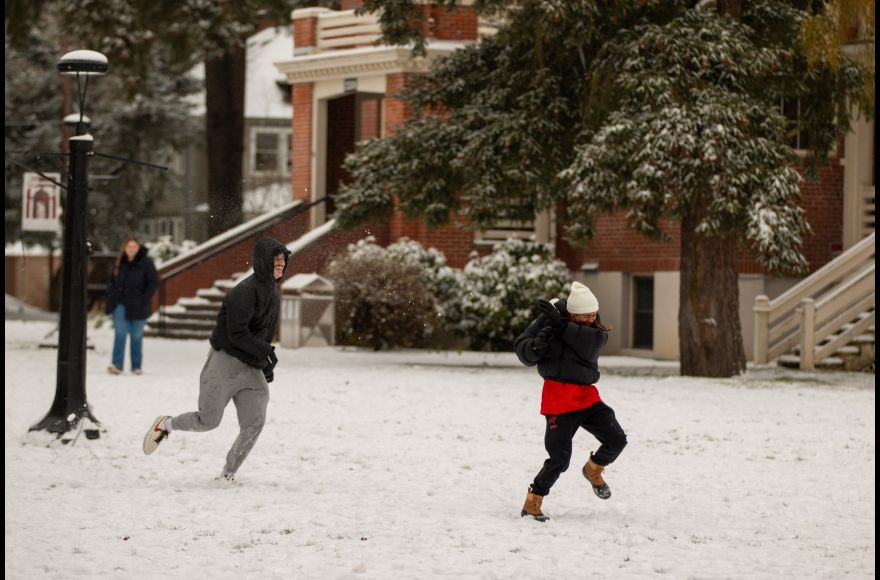 Students laugh during a snowball fight on Pacific's Forest Grove Campus.