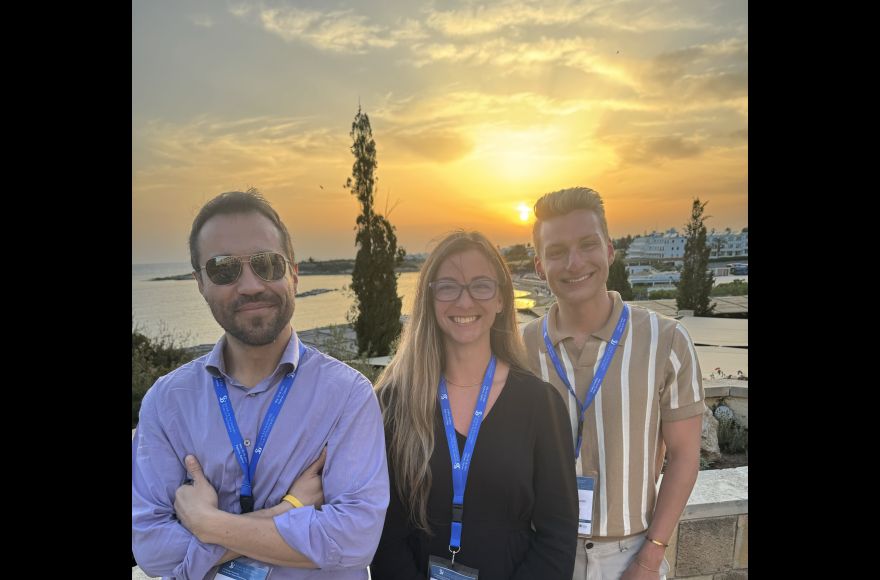 Pacific University student and faculty against sunset on roof after a conference