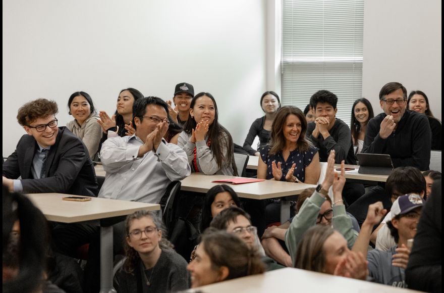 students and President Coyle applaud student presenters