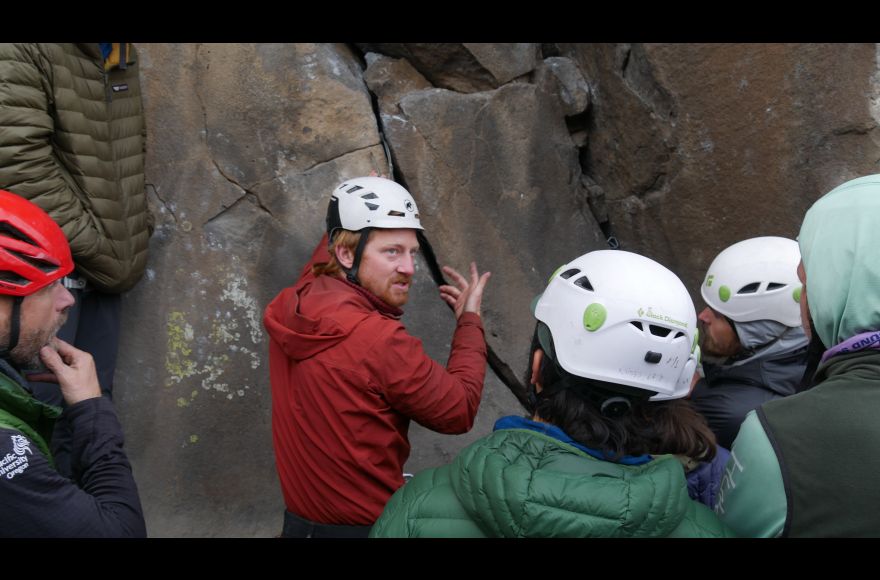 Pacific instructor demonstrates rock climbing technique